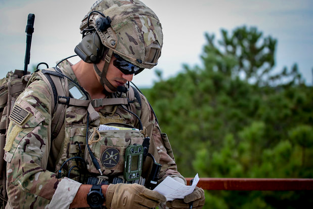 Soldier reviewing data on notes
